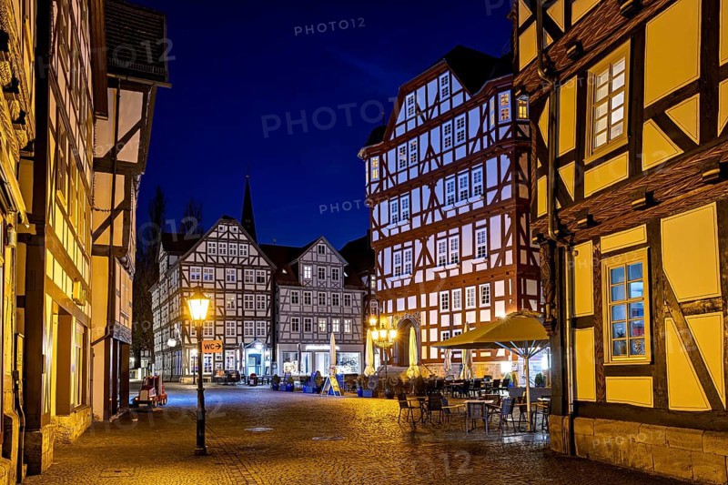 Night scene with illuminated half-timbered houses and a quiet, historic atmosphere, The old town centre of Melsungen