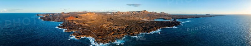 Coast with lava fields, volcanic landscape near Los Hervideros with red volcano Montaña Bermeja, in the evening light, aerial view, Lanzarote, Canary Islands, Spain