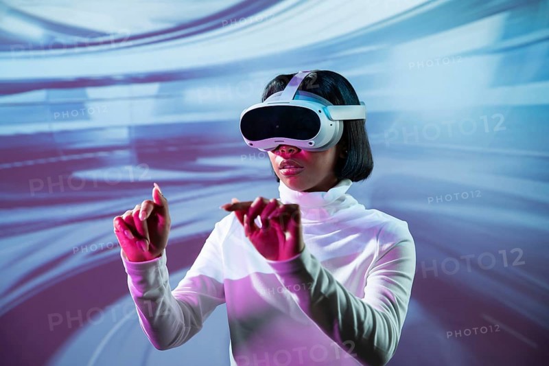 Latin woman immersed in a virtual reality experience, wearing VR glasses and interacting with a digital environment. The futuristic setting emphasizes innovation and technology
