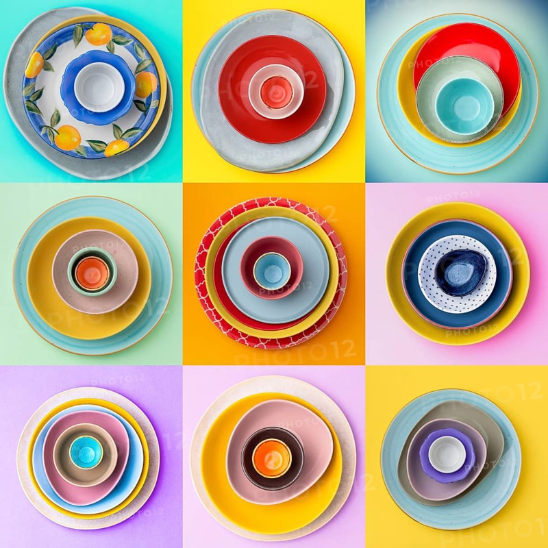 A grid layout of colorful plates and bowls showcases vibrant patterns and colors, creating a lively and artistic arrangement on various backgrounds