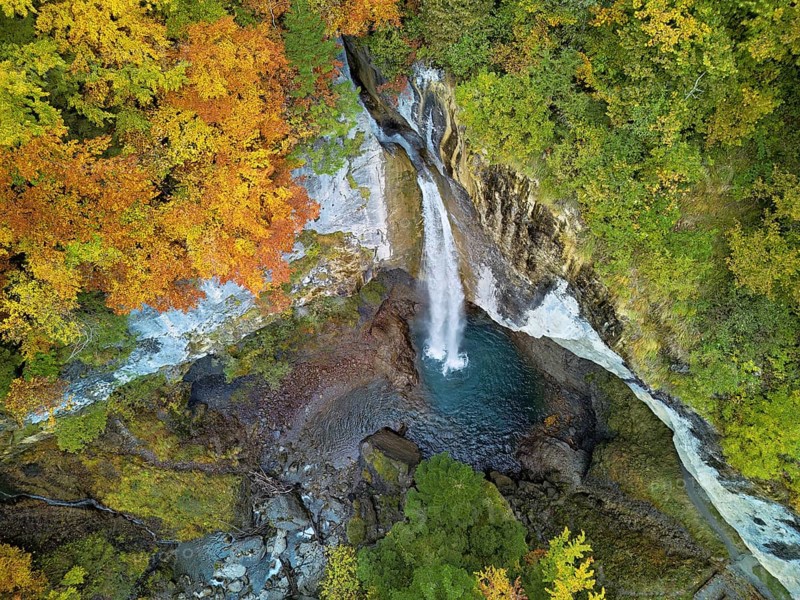 Aerial view of Berglistüber waterfall in autumn-colored surroundings, Linthal, Klausenpass, Canton of Glarus, Switzerland