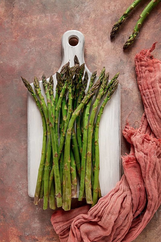 Bouquet of fresh asparagus, on an abstract background, top view, rustic, no people