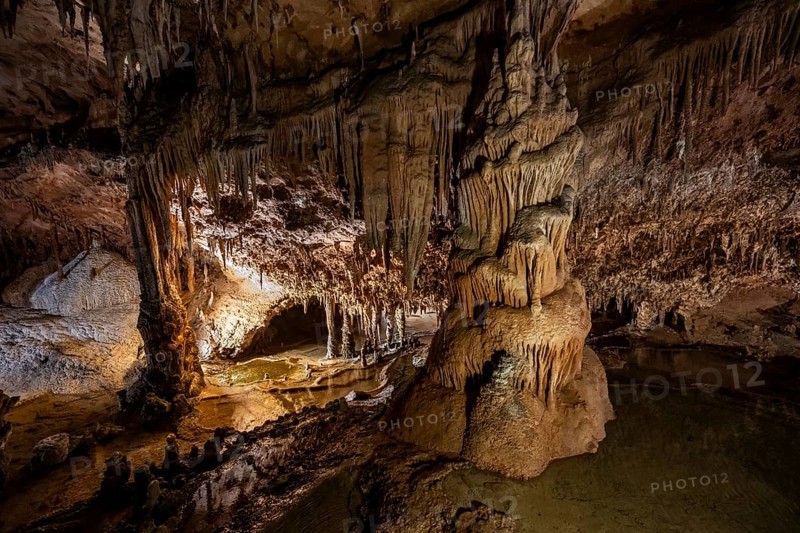 Stalactites and stalagmites, rock formations in a stalactite cave with water basin, Grotta del Fico, Gulf of Orosei, Baunei, Sardinia, Italy