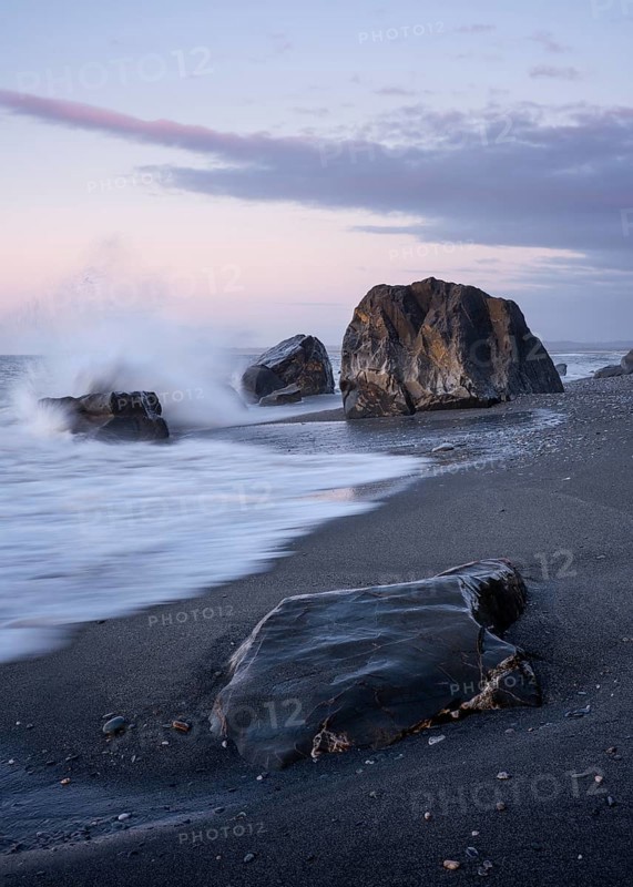 Okarito Beach, rocks, ocean, sandy beach. In the evening. long exposure. Westland Tai Poutini National Park, West Coast, South Island, New Zealand