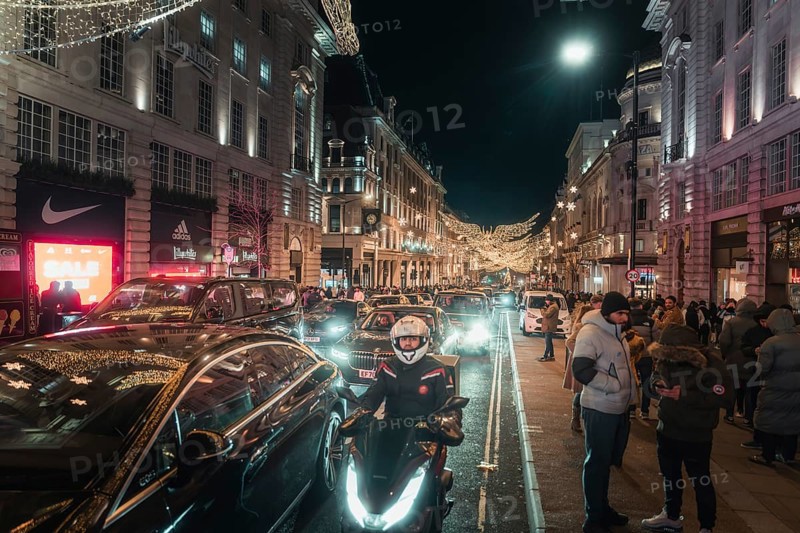 Busy street at night with traffic and brightly lit buildings and roads, New Year's Eve London, United Kingdom