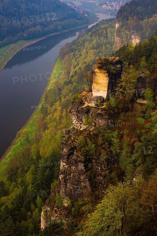 The bright lit Wartturm above the Elbe river seen from the Bastei rocks near the village of Rathen in Saxon Switzerland National Park, Saxony, Germany. On November 22, 2000 the Wartturm was the scene of a spectacular rockfall