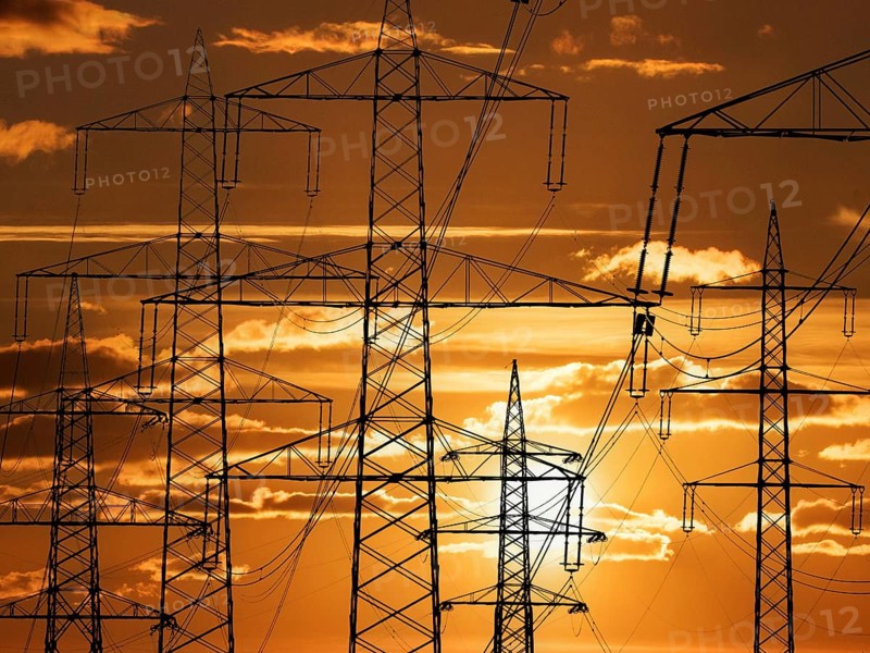 The mast of a high-voltage line in front of sunset, Lower Saxony, Federal Republic of Germany