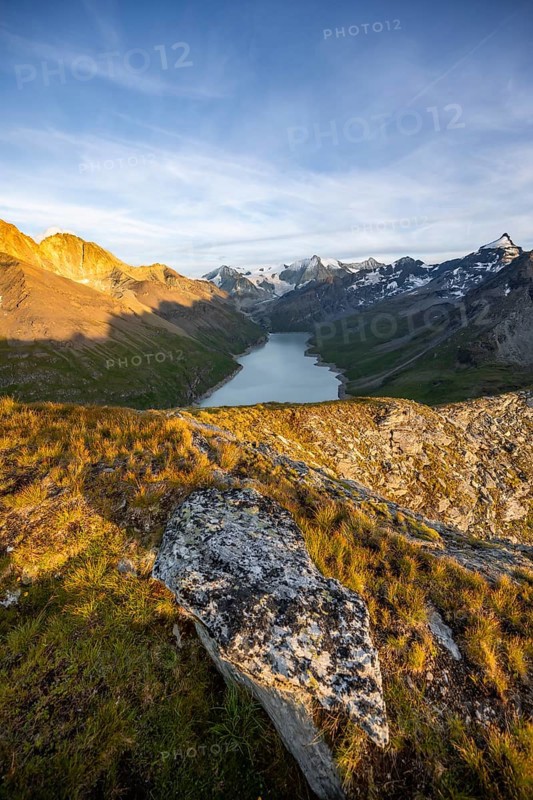 Picturesque mountain landscape at the summit Mont de la Blana at sunset, view of blue mountain lake, reservoir Lac des Dix and summit Mont Blanc de Cheilon with glacier, Hérémence, Valais, Western Alps, Switzerland