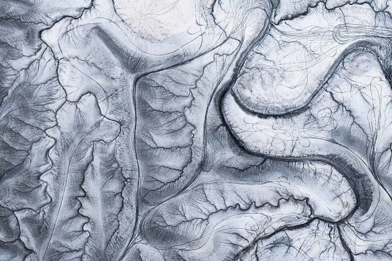A captivating aerial shot of the unique and intricate natural patterns at Moonscape Overlook in Utah, resembling a lunar landscape