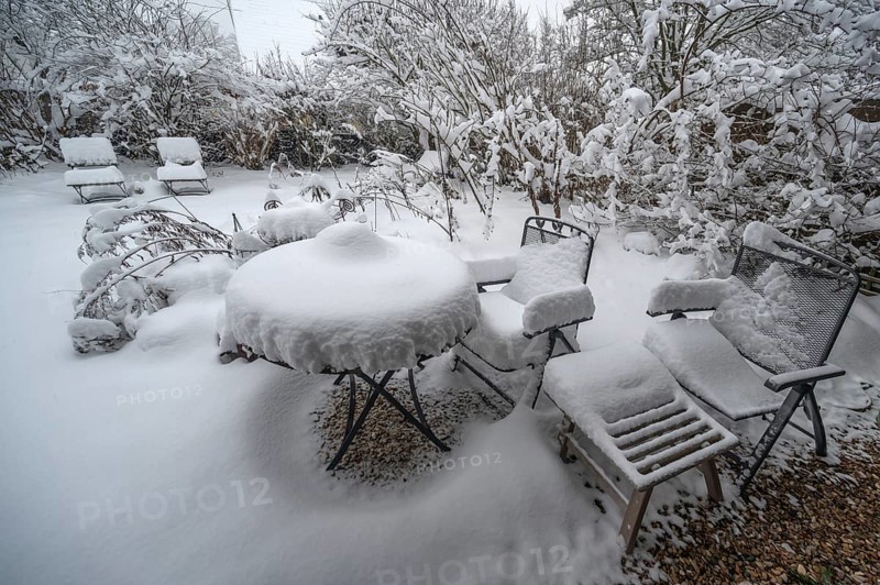 Snowy seating in a garden, Eckental, Middle Franconia, Bavaria, Germany
