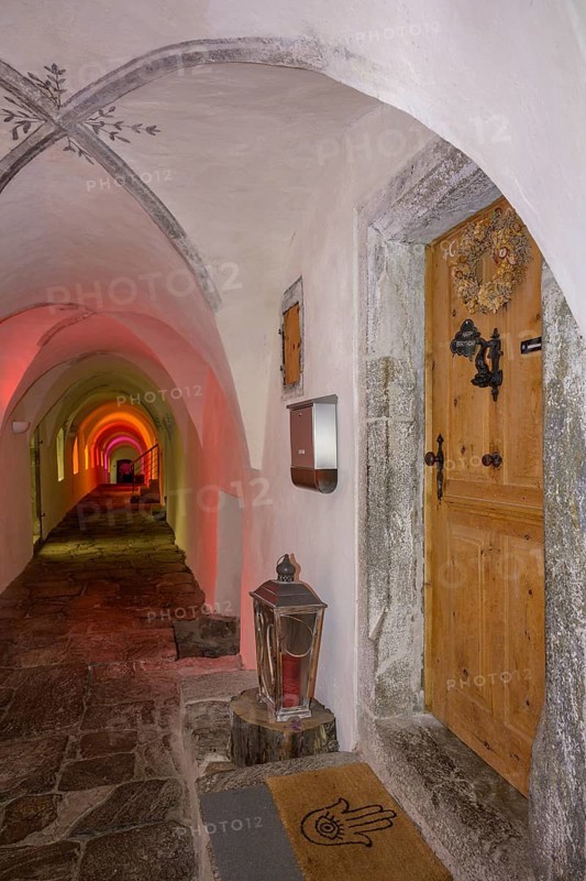 Colourfully illuminated cloister in the Carthusian monastery of Allerengelberg, Schnalstal Valley, Karthaus, South Tyrol, Italy