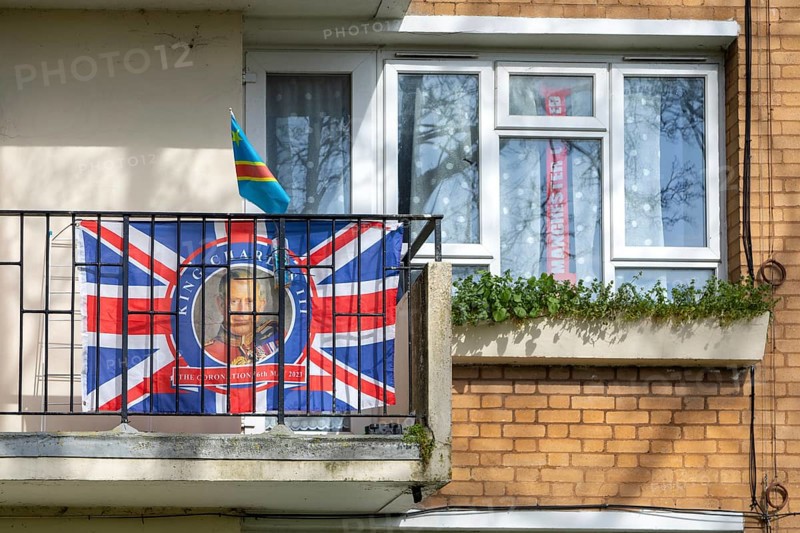 Patriotic Union Jack flag featuring King Charles on balcony of flat, Sydenham, Lewisham, London, SE26, England, UK