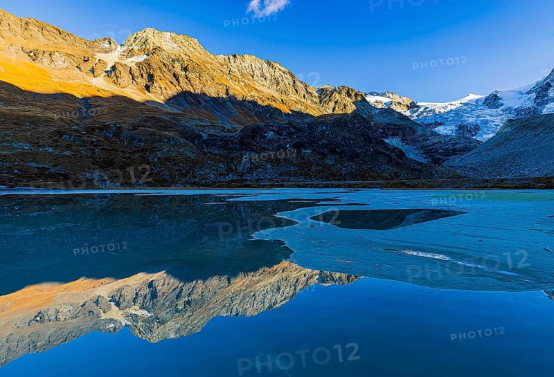 The Moiry glacier and mountain peaks are reflected in Lac de Chateaupre, Val d'Anniviers, Valais Alps, Canton of Valais, Switzerland