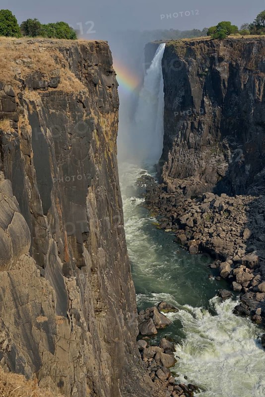 Rainbow over Victoria Falls on the Zambezi River, UNESCO World Heritage Site since 1989, Victoria Falls, Matabeleland North Province, Zimbabwe