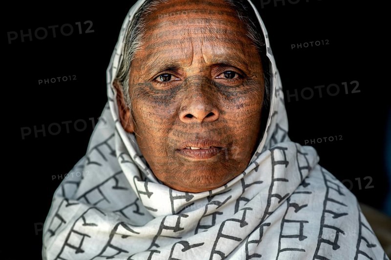 Portrait of a woman from the Ramnami caste (Chhattisgarh, India), As a sign of devotion, Ramnami people used to tattoo their body and their face with the name of Rama, one of the main hindu god. Nowadays, this tradition is disappearing. Indeed, few of them are still tattooed, the younger generation fearing discrimination. The caste (or sect) is born in the end of the 19th century as a way to protest against the supremacy of the higher classes in the hindu hierarchical system. Comprised of low caste hindus, they dont accept the caste system, they practise a form of bhakti (devotion) dedicated to the god Rama