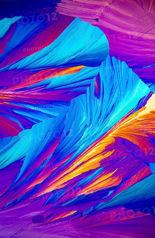 Microscopic image showcasing vivid Adipic acid, crystals in stunning shades of blue, purple, and red
