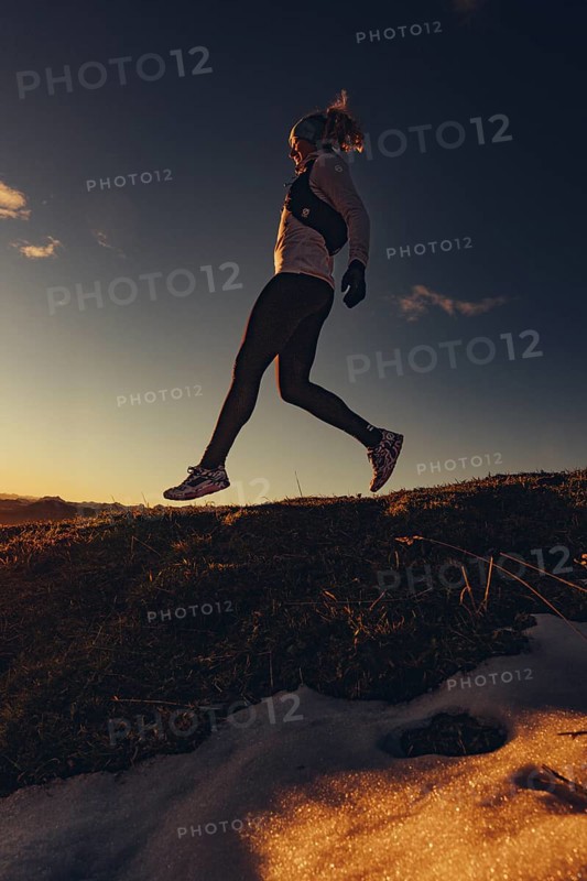Trail running in autumn on the Jochberg on Lake Walchensee against the wonderful backdrop of the Alps, Bavaria, Germany