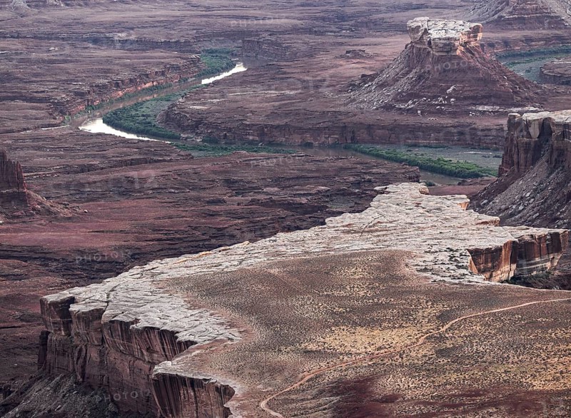 Aerial view of Canyonland national park striking landscape showcasing a winding river through rugged, layered rock formations, highlighting the natural beauty of this iconic location