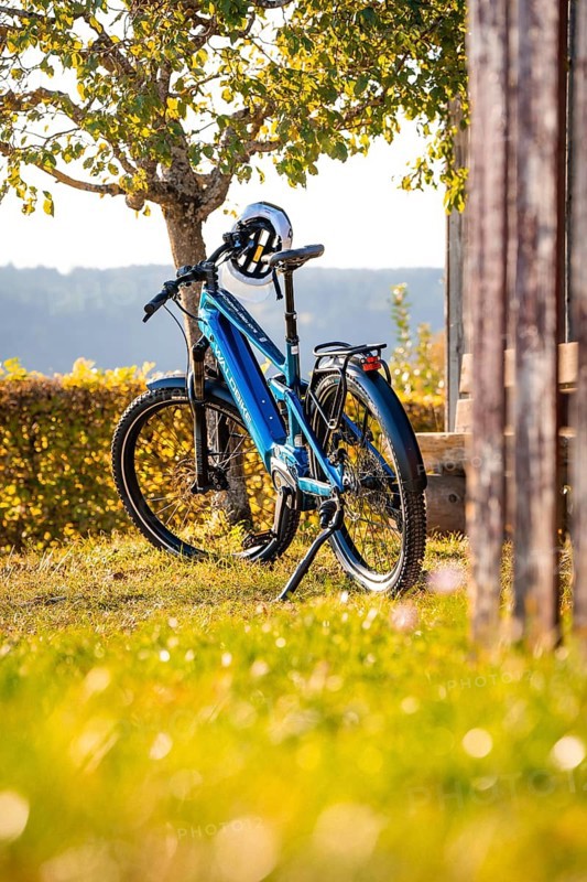 A bicycle with helmet standing next to a tree in a rural area, e-bike, forest bike, Calw, district of Calw, Black Forest, Germany