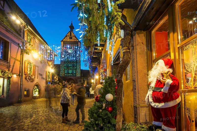 Colour-illuminated and Christmassy decorated half-timbered houses, blue hour, Christmas market, Riquewihr, Grand Est, Haut-Rhin, Alsace, France