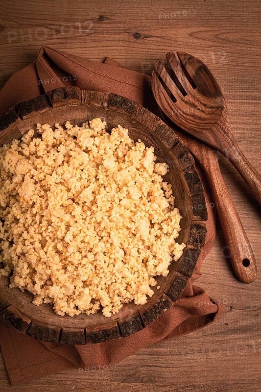 Cooked couscous, in a wooden bowl, top view, no people