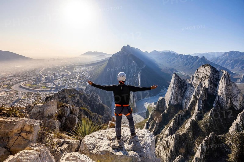 Man embraces breathtaking views while practicing mountaineering and rappelling in Eagleâ€™s Nest, Monterrey. Capturing adventure, nature's beauty, and the thrill of climbing