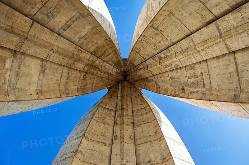Symmetrical view of the concrete arches of a modern monument, The National Independence Monument in Algiers Algeria