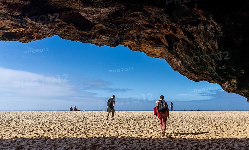 Tourists watch the waves of the Atlantic on the rocky plateau of Sito, also known as Forte São Miguel, a surfing paradise with monster waves in the months of November to February, Nazaré, Portugal