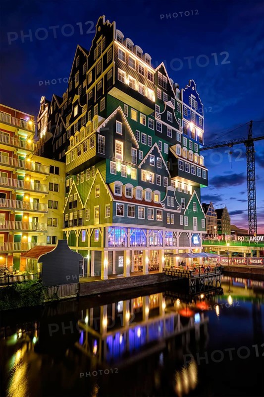 ZAANDAM, NETHERLANDS, MAY 21, 2018: Inntel Hotel in Zaandam illuminated at night. Design of 12-storey tall building opened in 2009 is the result of stacking a series of traditional Dutch houses