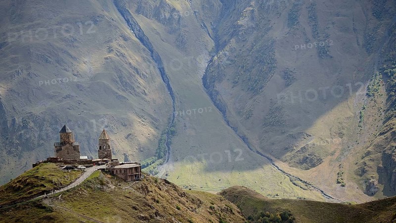Gergeti church on a mountain with breathtaking mountain scenery, Stepantsminda, Caucasus, Georgia