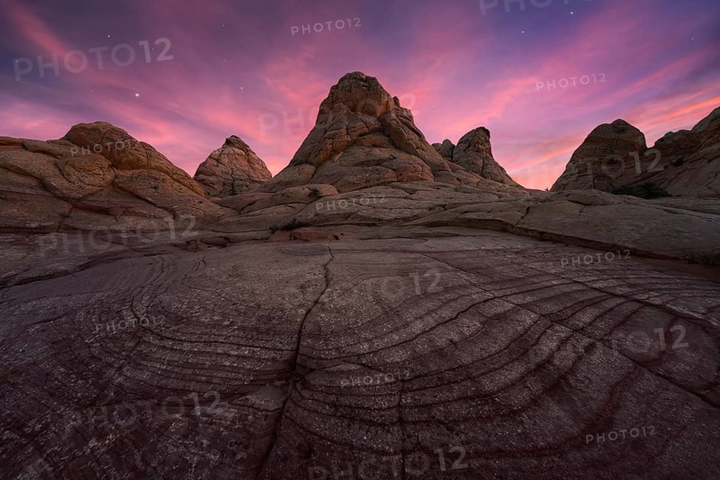 Majestic view of Coyote Buttes in the Paria Canyon-Vermilion Cliffs Wilderness, Arizona, featuring striking rock formations under a vibrant twilight sky