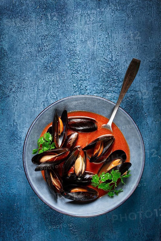 Fra Diavolo mussels, mussels in tomato sauce, Italian dish, on a blue background, homemade, no people