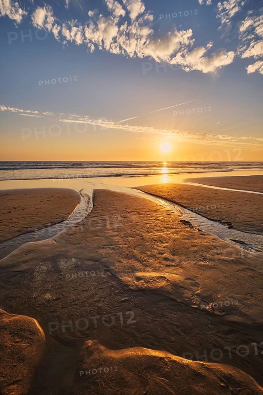 Atlantic ocean sunset with surging waves at Fonte da Telha beach, Costa da Caparica, Portugal