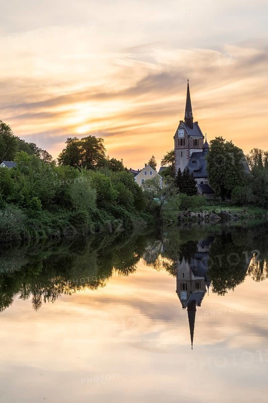 St. Pancratius Church in the evening with reflection in the Freiberger Mulde, Tragnitz, Leisnig, Saxony, Germany