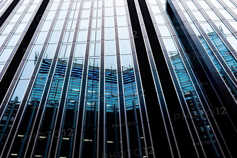 Modern abstract reflections in glass fronted commercial office buildings in the financial district of the British capital London