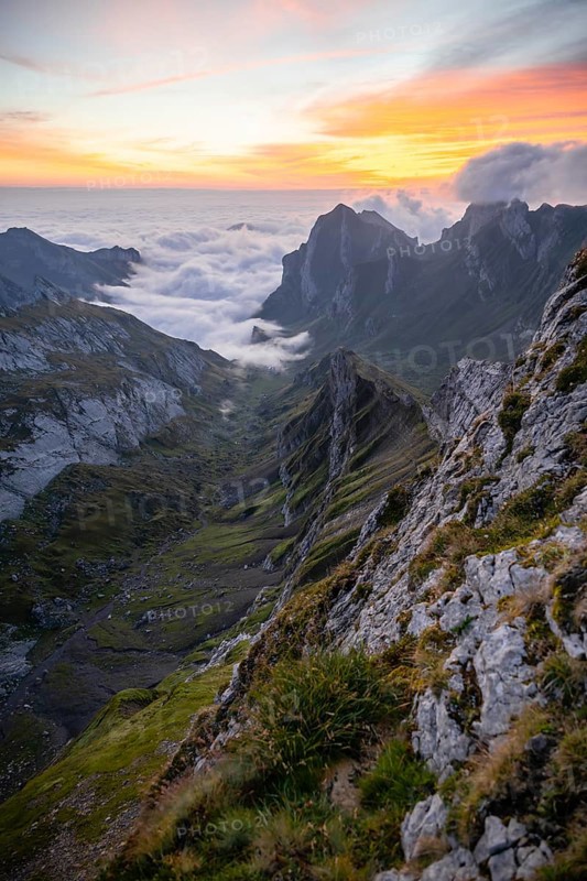 View over Säntis mountains into the valley of Meglisalp at sunrise, high fog in the valley, Säntis, Appenzell Ausserrhoden, Appenzell Alps, Switzerland