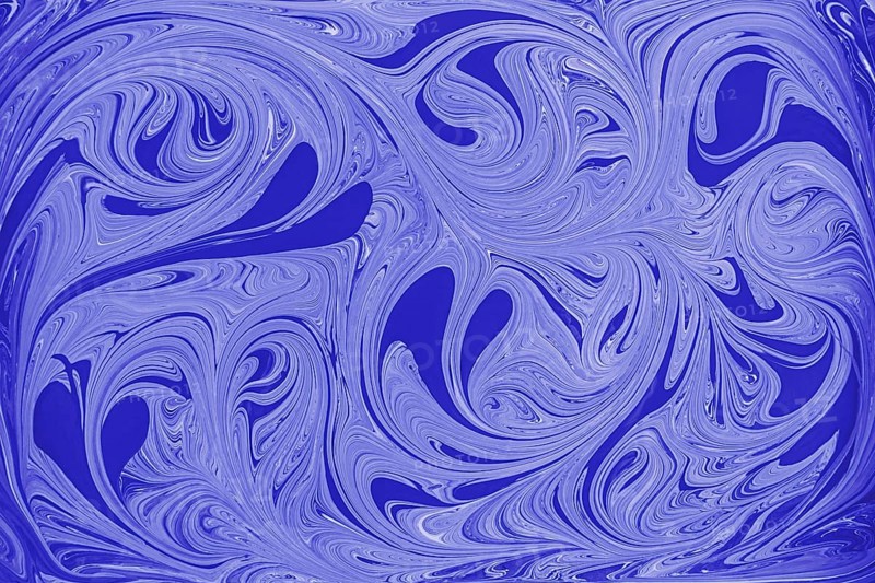 This image showcases an abstract floral pattern of swirling blue and white acrylic paint, reminiscent of marble. The fluid motion and intricate design create a mesmerizing visual effect