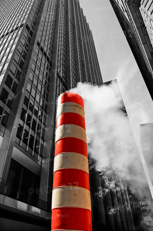 Steaming chimney at a construction site behind a skyscraper, New York City, USA