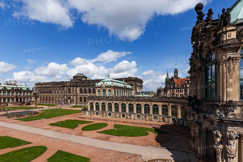The Zwinger Palace in Dresden, Germany, showcases its stunning baroque architecture under a vibrant blue sky. This historic landmark captivates with its intricate details and elegant design