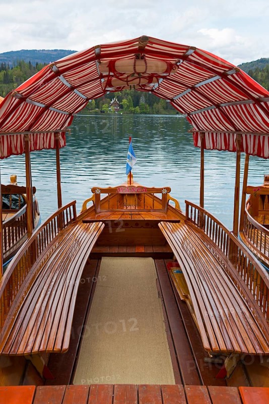 Interior view of a wooden boat with a red and white roof floating on a calm lake, Lake Bled, Lake Veldes, Blejsko jezero, Bled, Veldes, Feldes, Upper Carniola region, Gorenjska, Slovenia, Balkans