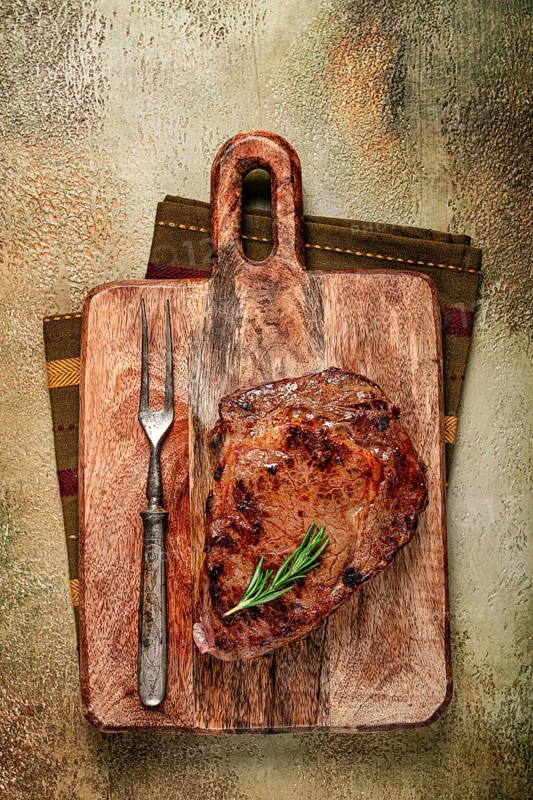 Grilled steak, beef steak, rib eye steak, on a chopping board, top view, no people