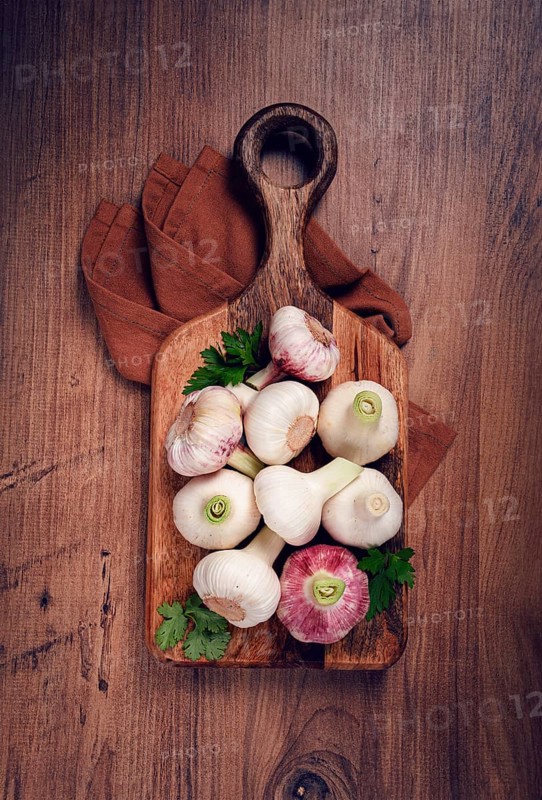 Fresh young garlic, white and purple color, on a wooden table, no people