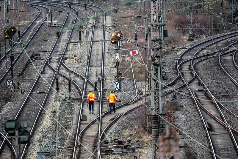 Railway employees check the tracks and switches at the Hagen-Vorhalle marshalling yard, is one of the 9 largest in Germany, it is located on the Wuppertal-Dortmund railway line and has 40 directional tracks on which freight trains of all types are assembled, North Rhine-Westphalia, Germany
