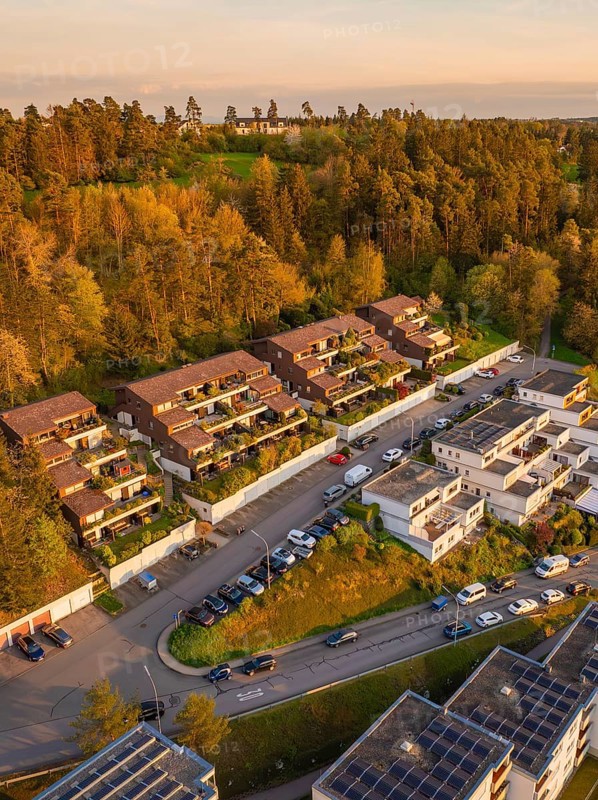 Terraced houses and residential buildings along a road, embedded in a wooded landscape, Nagold, Black Forest, Germany