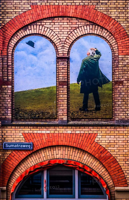 Artistic wall design on the Sumatraweg, scene strongly reminiscent of the surrealist works of René Magritte, city panorama, Rotterdam, the Netherlands