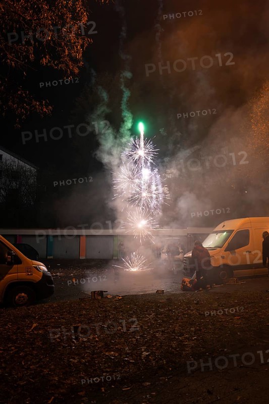 Nocturnal fireworks spectacle on a street with spectators and smoke, Stuttgart Birkach, Germany