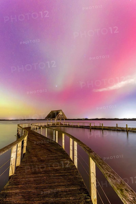 Wooden jetty and Northern Lights, Aurora borealis, polar lights over Lake Hemmelsdorf, Hemmelsdorfer See near Lübeck, Schleswig-Holstein, Germany