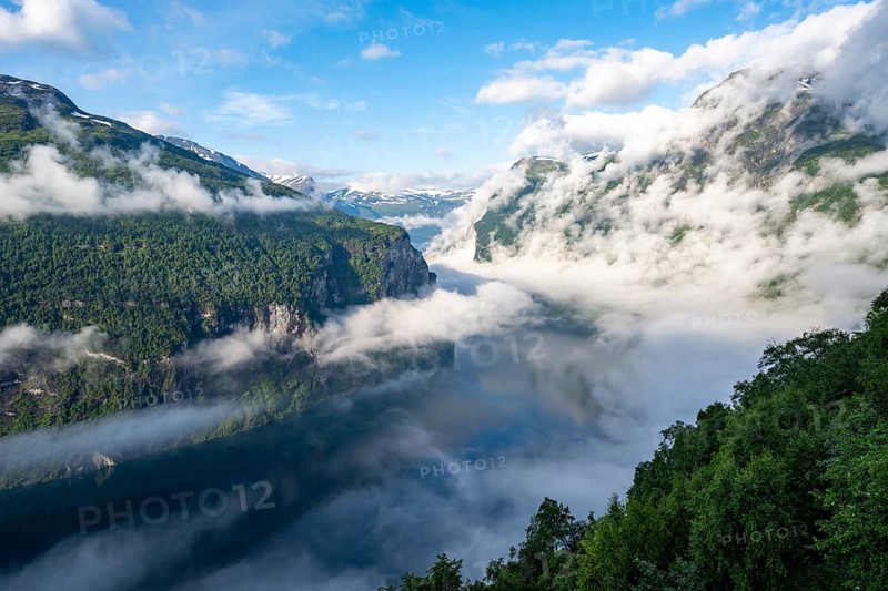 View over the Geirangerfjord, atmospheric clouds over the fjord in the morning light, Ørnesvingen viewpoint, near Geiranger, Møre og Romsdal, Norway