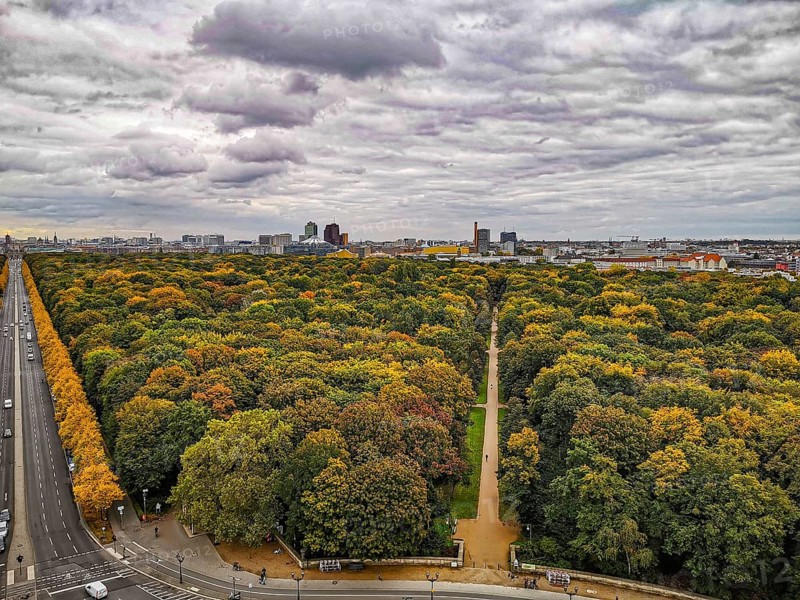 The city of Berlin in autumn with extensive forest and dramatic sky in the background, view from the Victory Column, Berlin