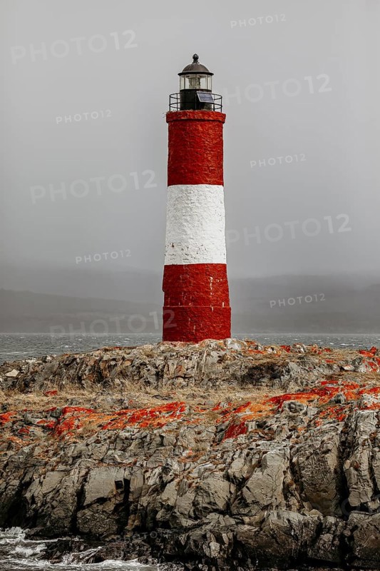 Lighthouse on a rocky island in the sea under a stormy sky, The lighthouse in the Beagle Channel near Ushuaia in Argentina